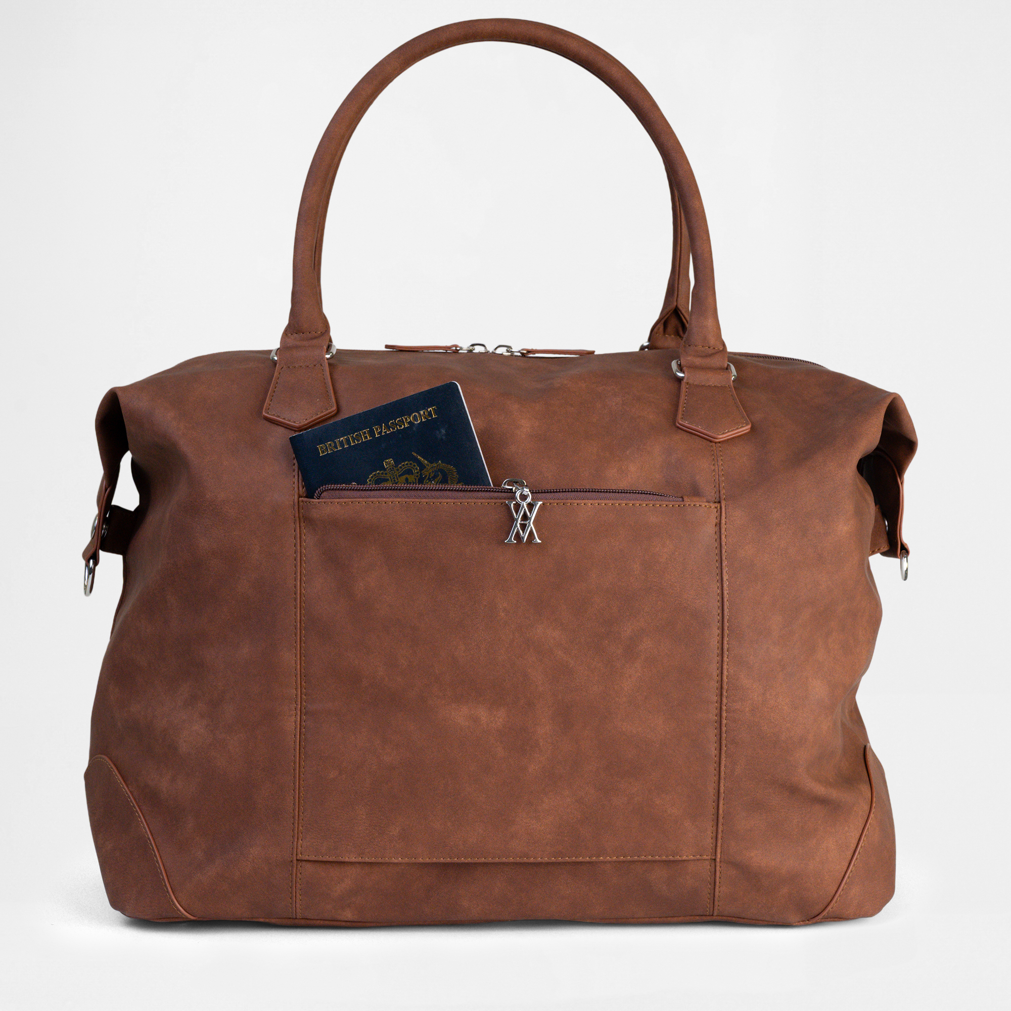 Close-up view of the Lisbon Weekender in Cognac with hidden passport pocket partially open.