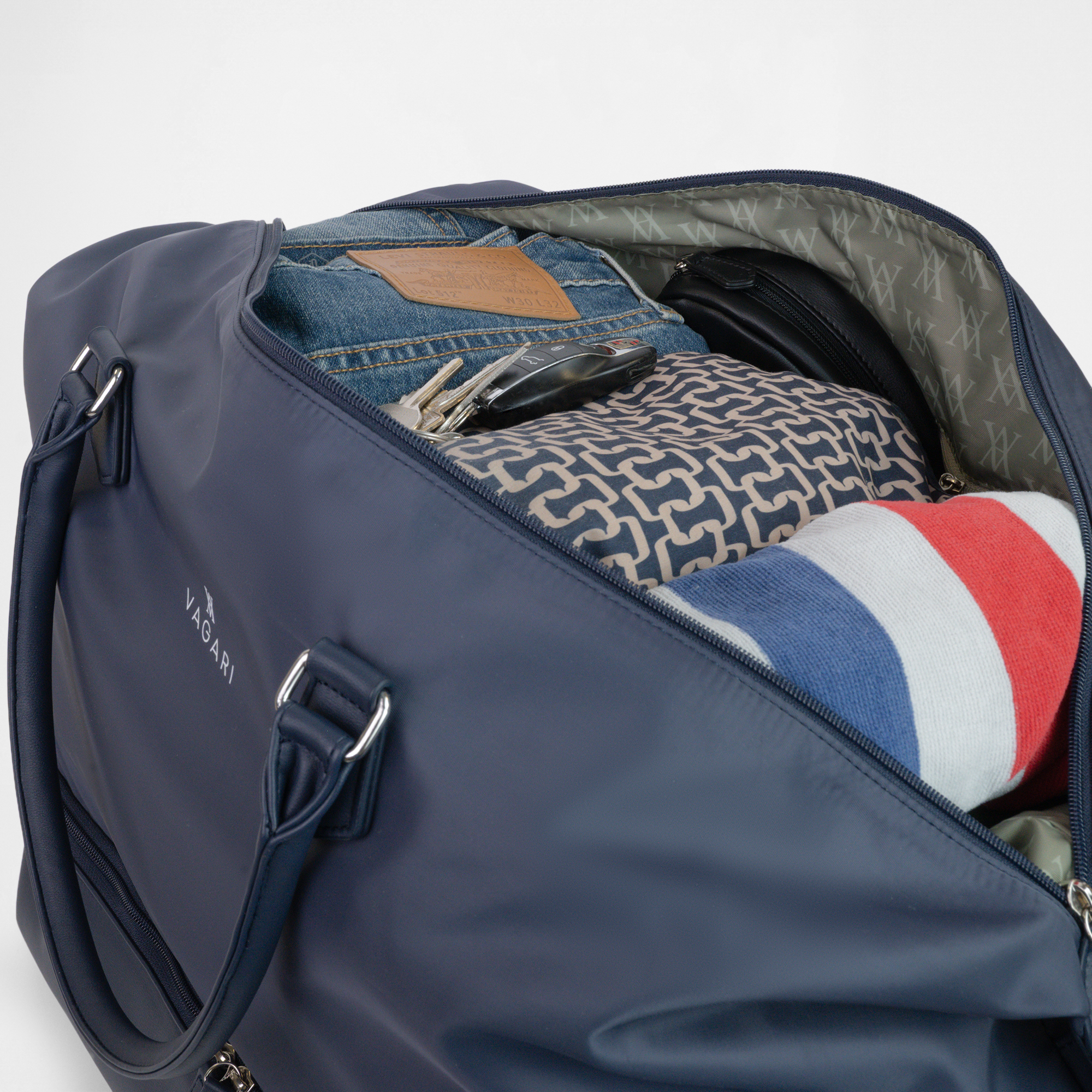 Interior view of the Athens Gym Bag in Navy packed with clothes, keys, and essentials
