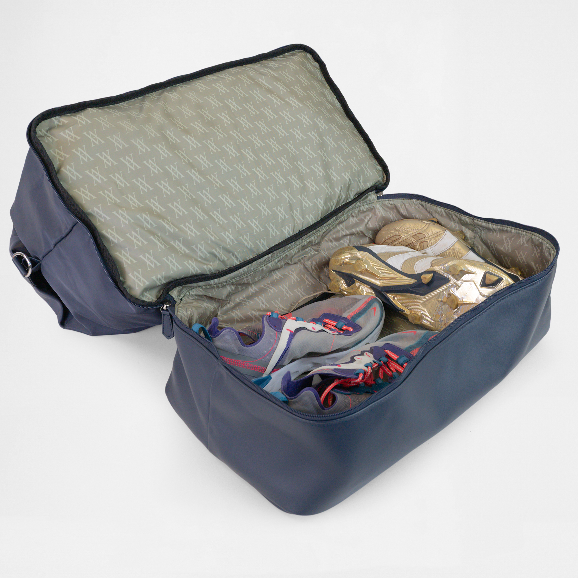Open shoe compartment of the Athens Gym Bag in Navy, storing trainers and footwear