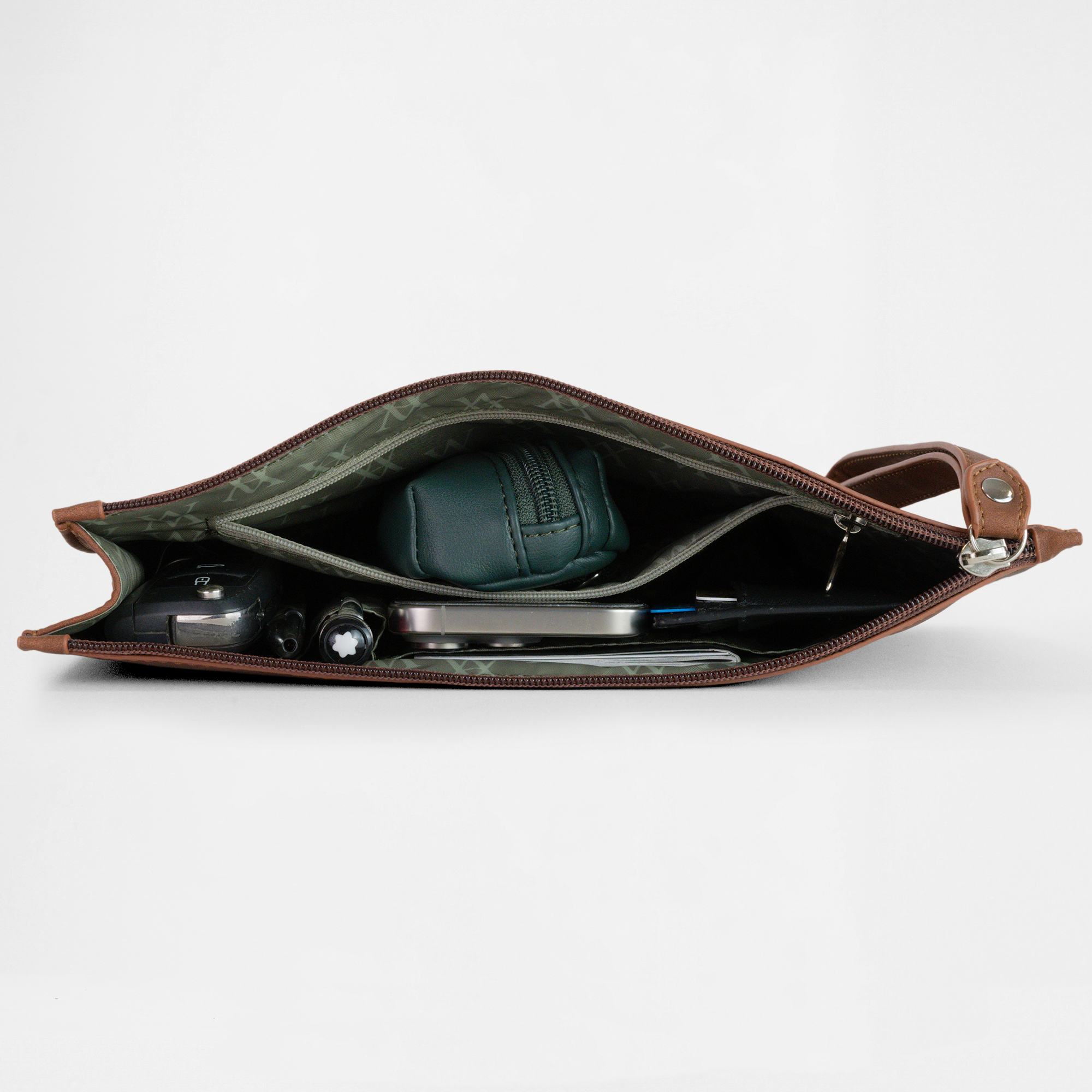 Open view of the Geneva Compact Pouch in Cognac, neatly packed with travel accessories inside.