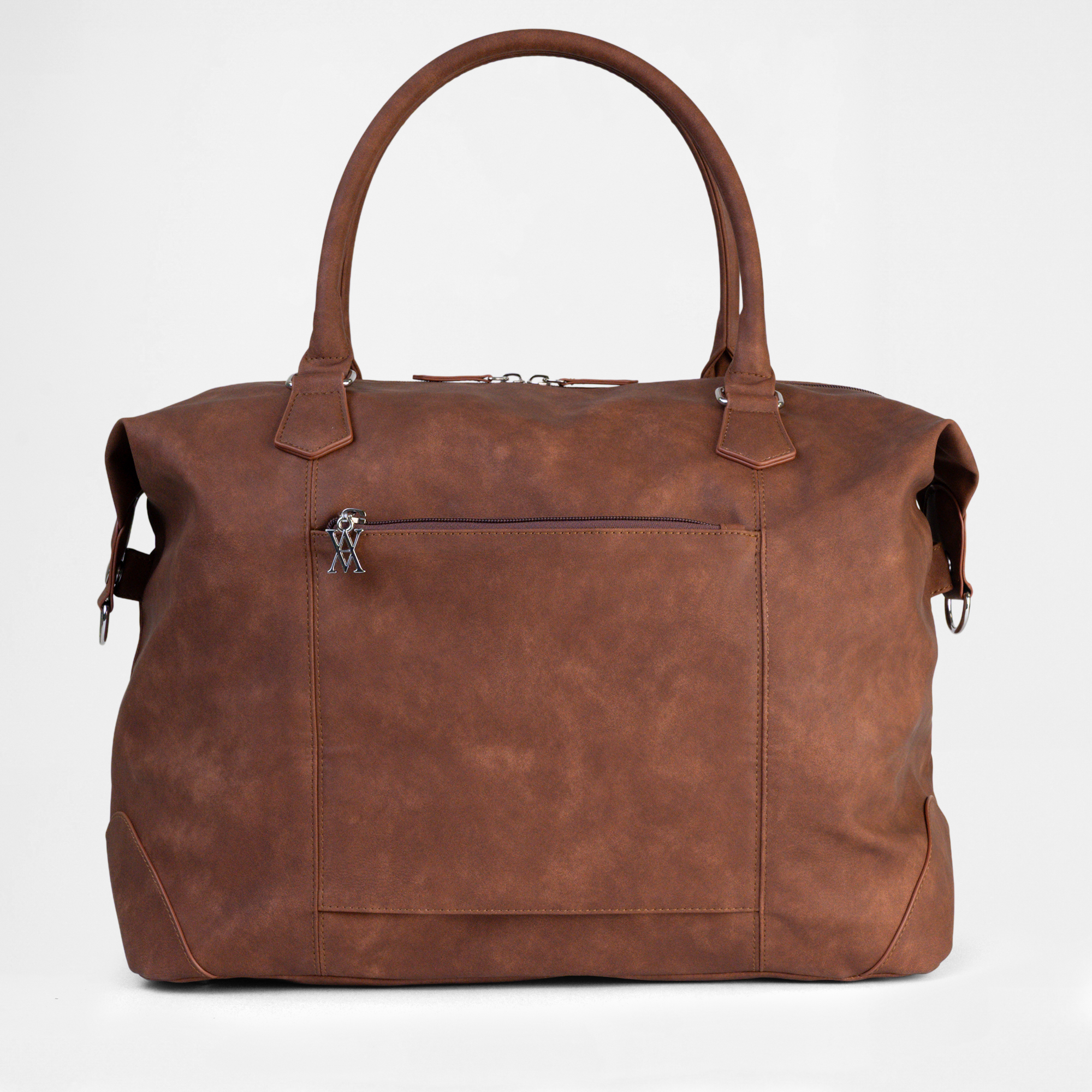 Detailed view of the Lisbon Weekender in Cognac, showing structured handles, external zipper pocket and textured faux-leather finish.
