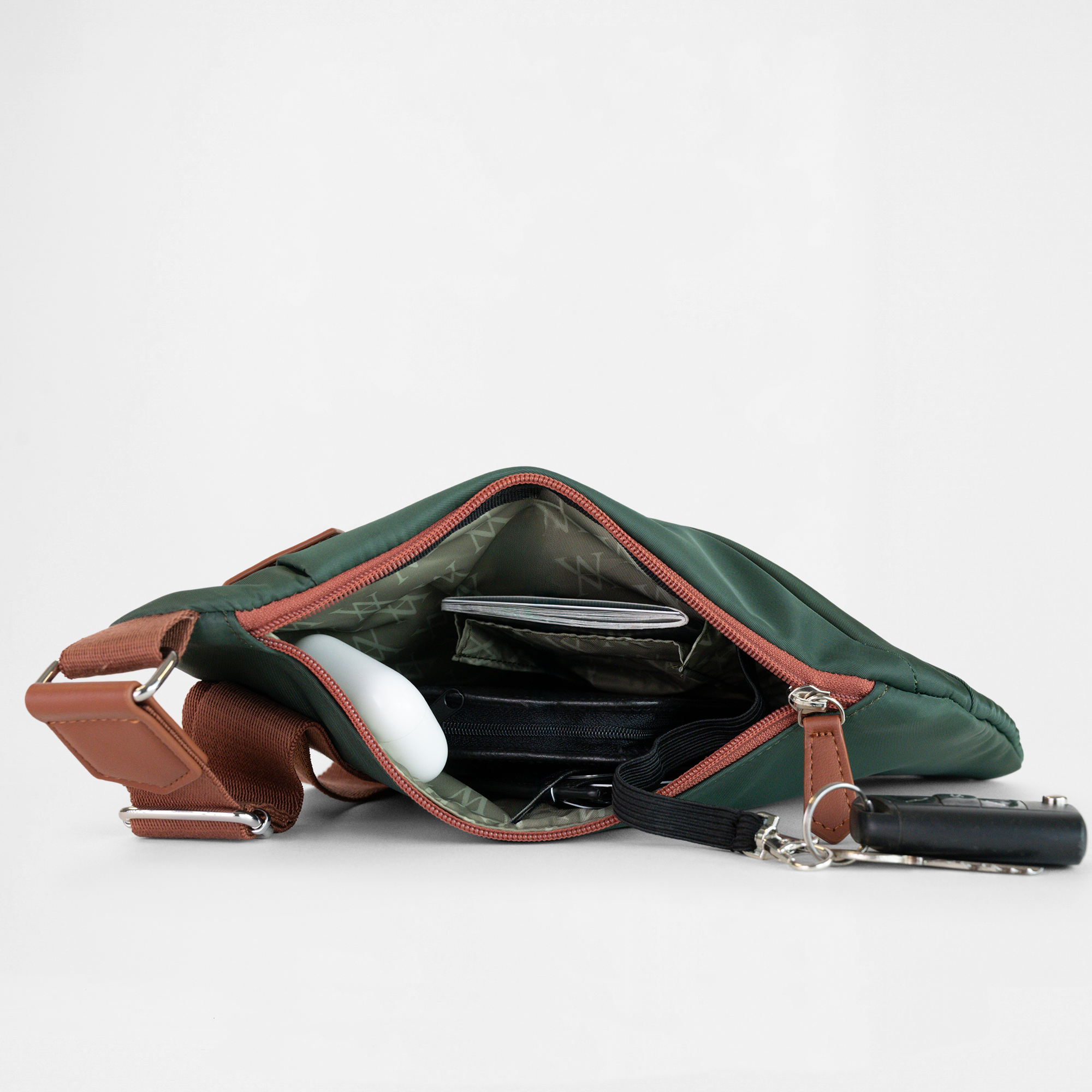 Interior view of the London Sling Bag in Green with Tan trim, showing built-in compartments for organised storage.