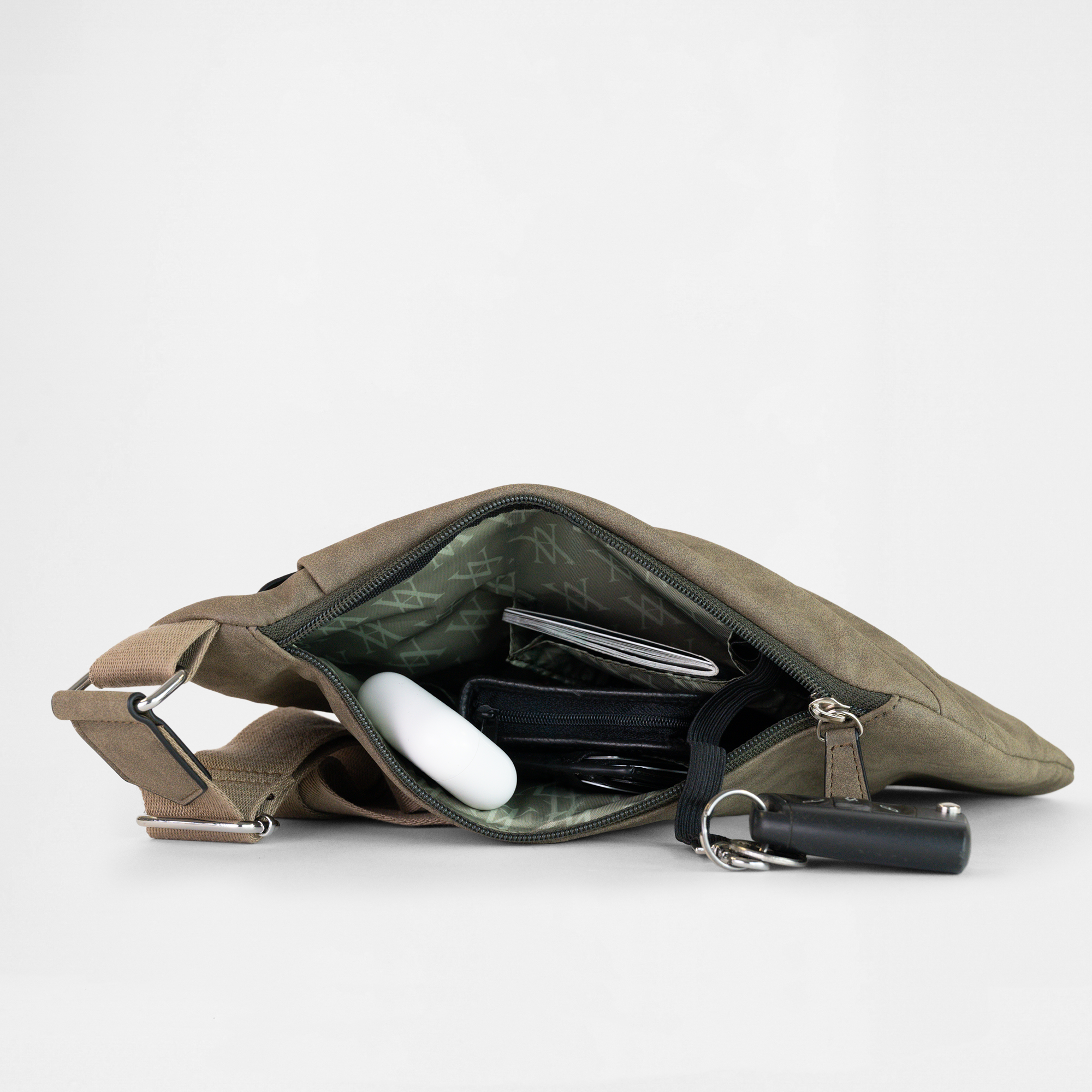 Interior view of the London Sling Bag in Olive Drab, showing built-in compartments and organised accessories.