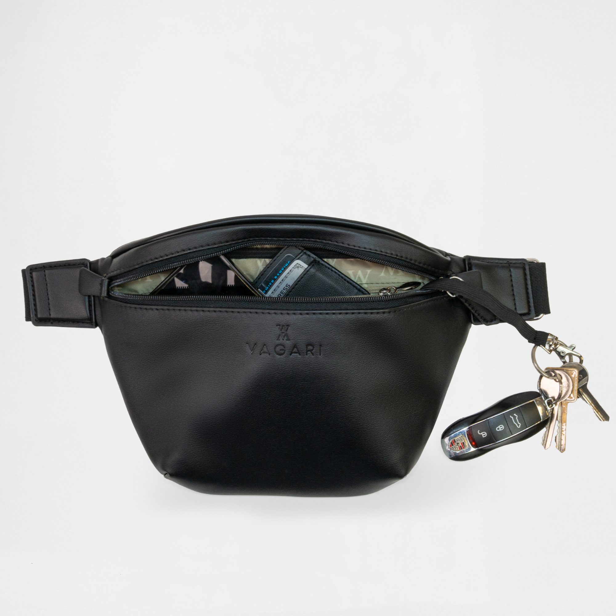 Miami Belt Bag in Black opened to reveal phone and wallet inside with keys attached to clip.